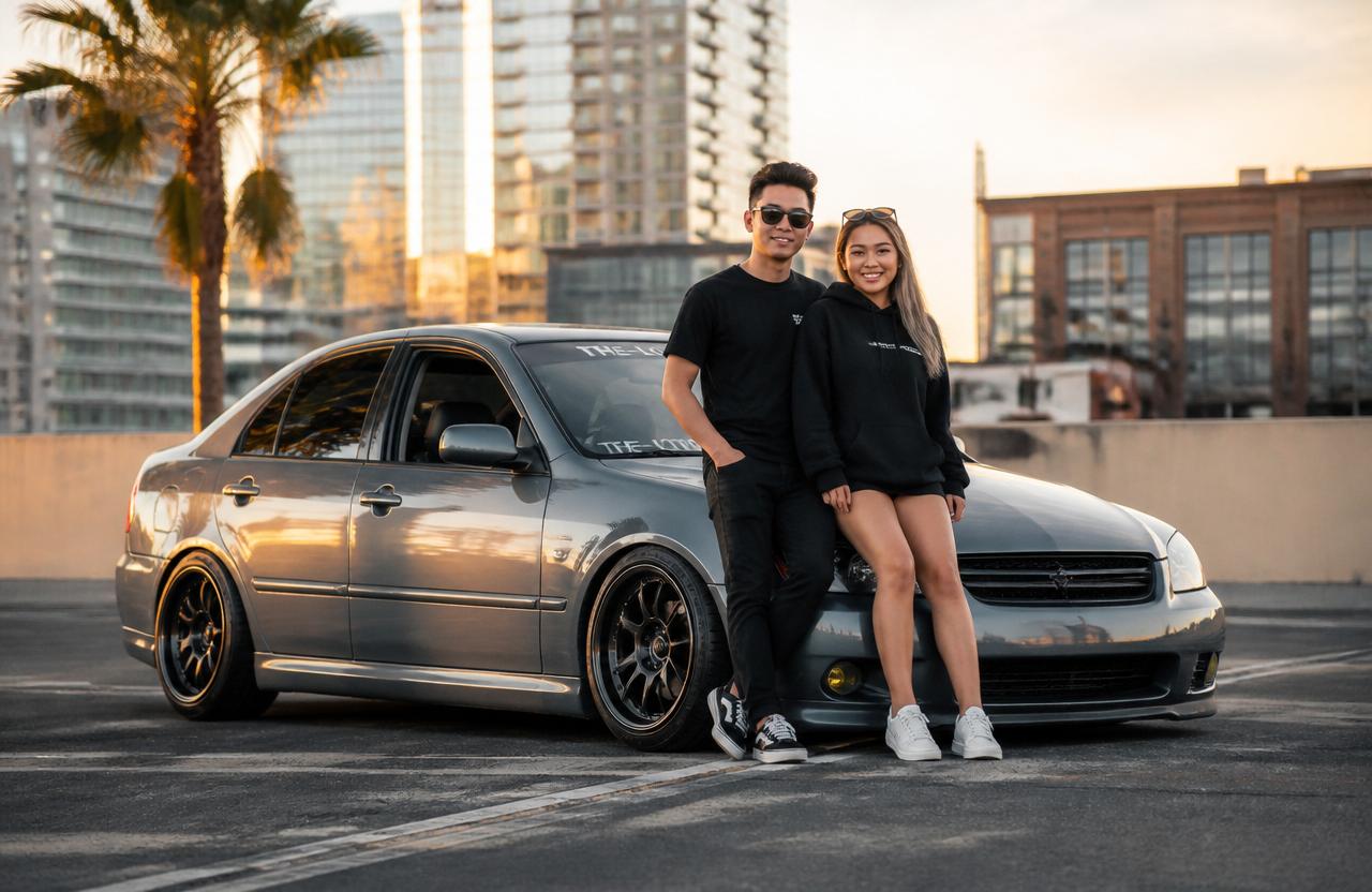 Two friends showing off a sport sedan with custom wheels